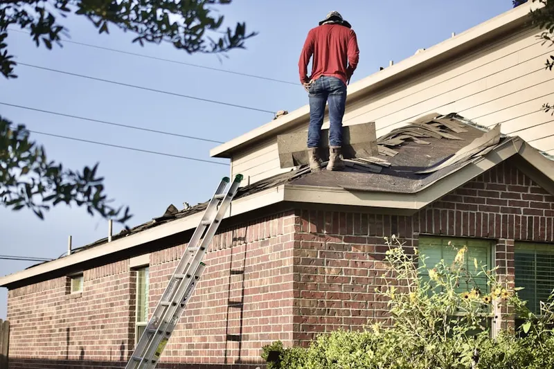 Professional roofer working on a residential roof in Adams Square